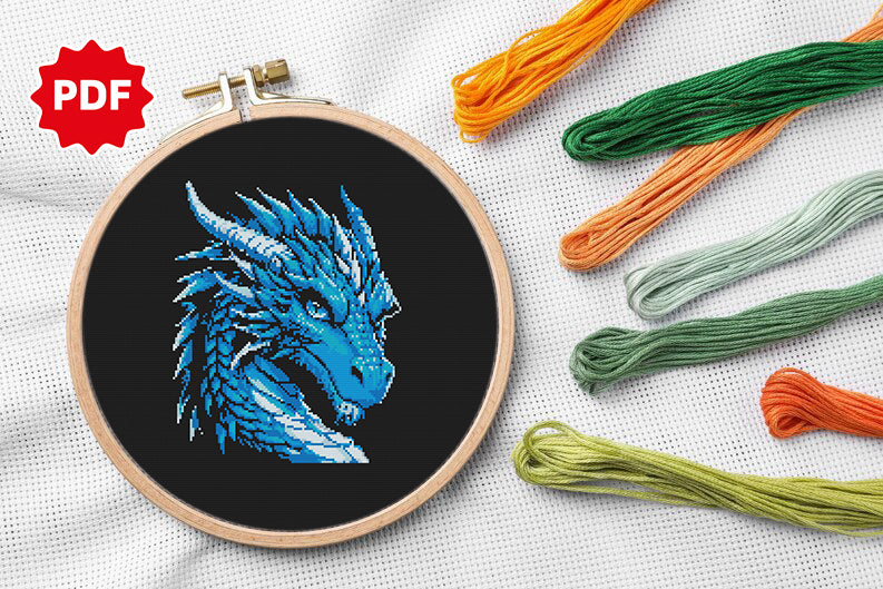 Fantasy blue dragon cross stitch, focused gaze and intricate details